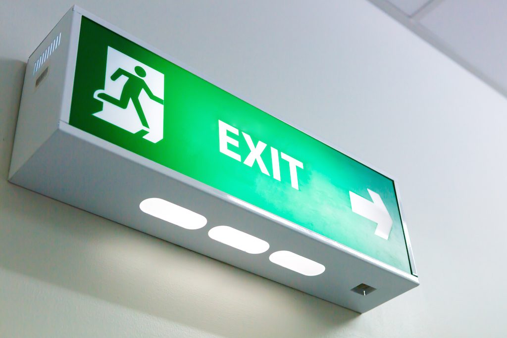 The Fire exit sign in big factory