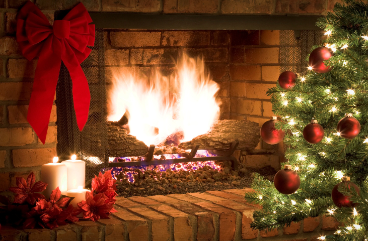 Open fire with Christmas decorations around it.