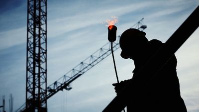 Man on a construction site with a naked flame