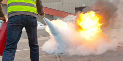 Fire Extinguisher Quiz Q4 Somebody putting a fire out.